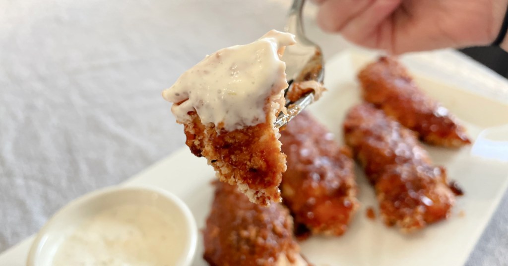 honey bbq chicken tenders dipped in ranch dressing 