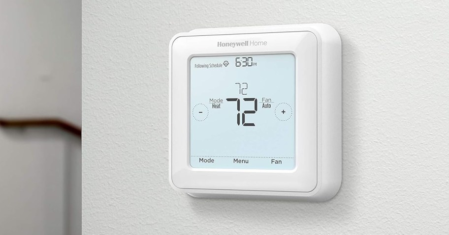 touchscreen thermostat on a white wall