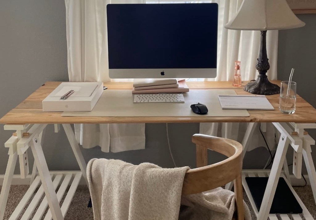 minimal office desk with apple computer and leather desk pad