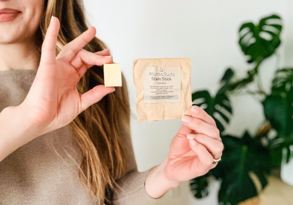 woman holding mamasuds stain stick with brown paper