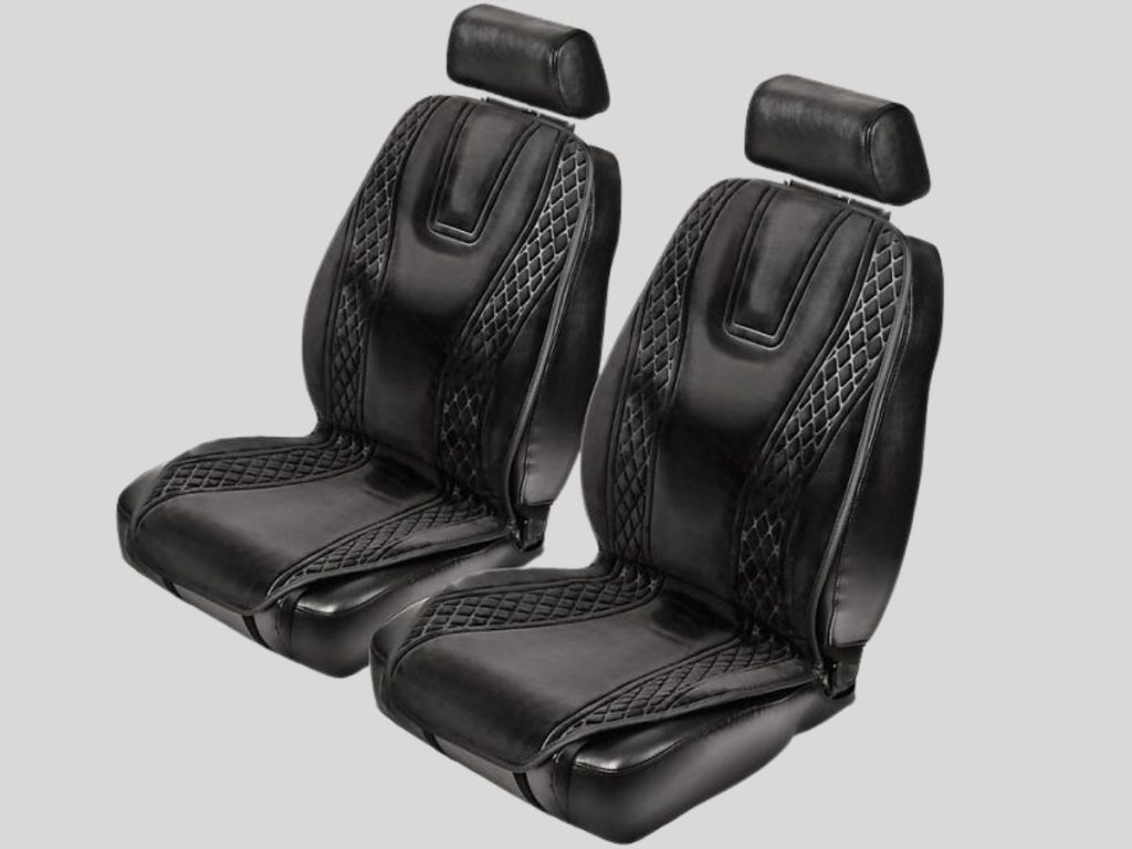 2 car seats with black heated seat covers on them