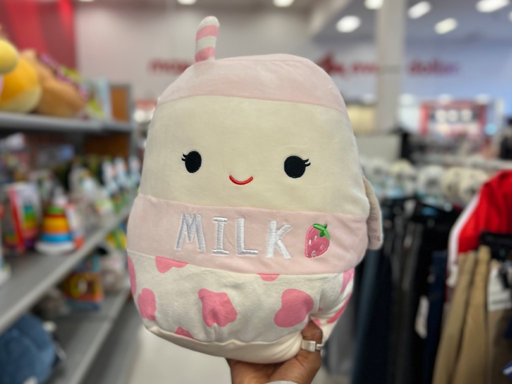 hand holding strawberry milk squishmallow