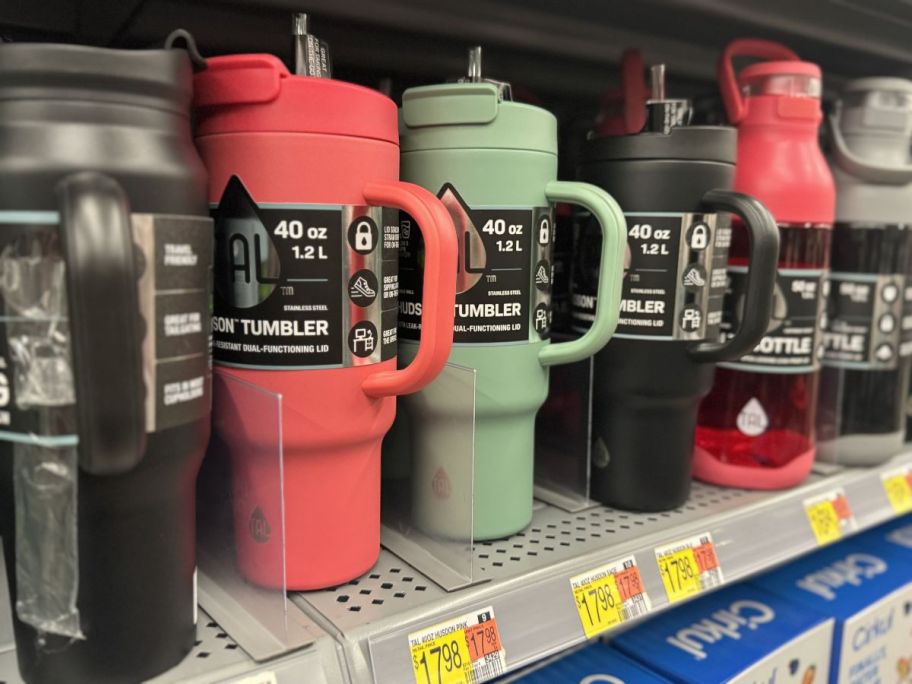 black, bright pink and sage green Tal tumblers on Walmart shelf