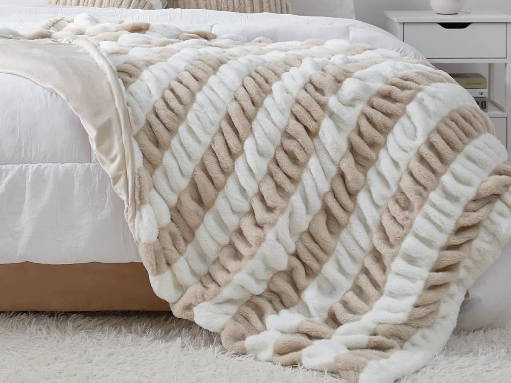 throw blanket displayed on the bed