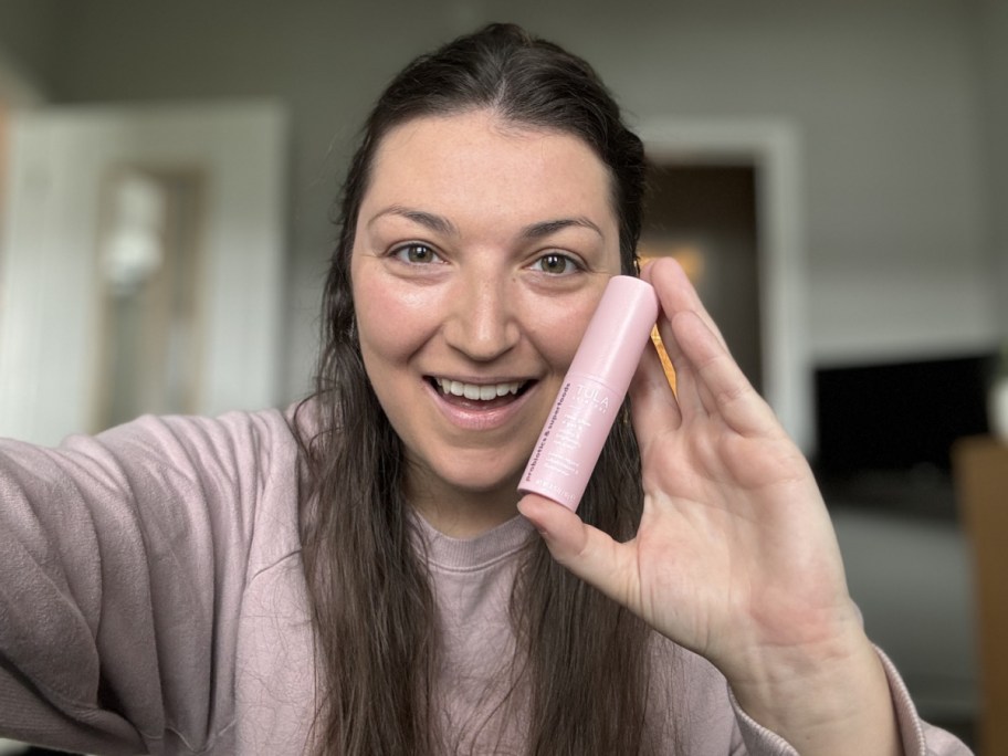 woman holding eye balm