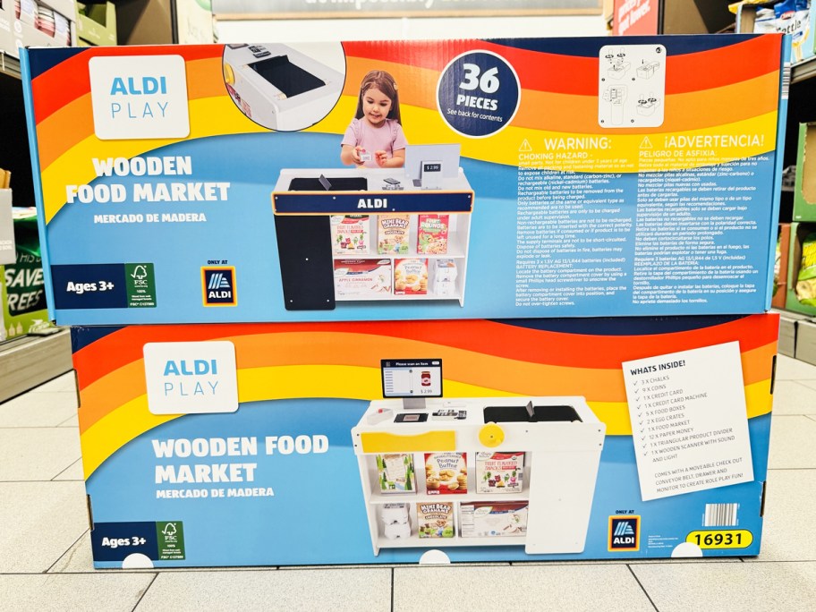 two stacked boxes of aldi wooden food market playsets 