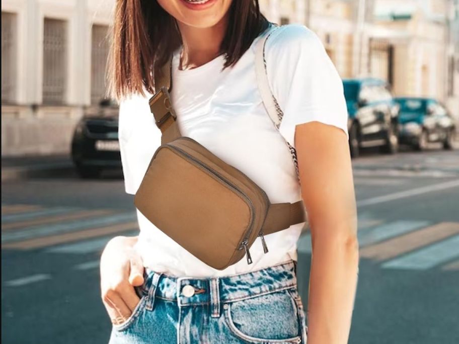 A woman wearing an Amazon Belt Bag in brown