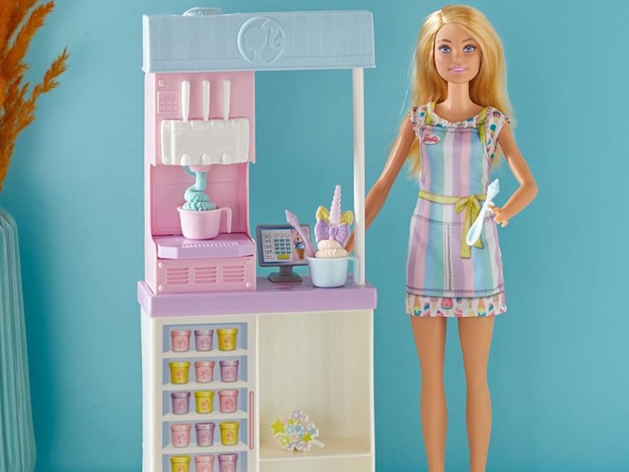 Barbie with ice cream shop next to her
