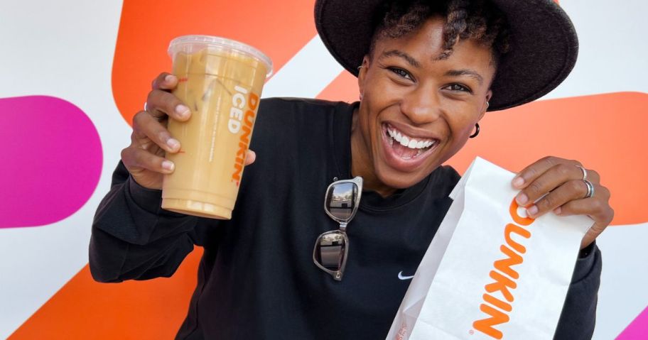 woman holding a Dunkin Iced Cofee