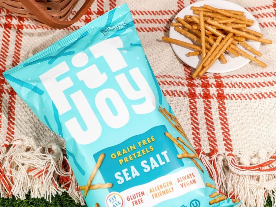 A bag of Fit Joy Pretzel Sticks next to a plate of them