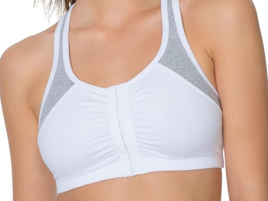 A woman wearing a Fruit of the Loom Front Close Sports Bra in white and grey 