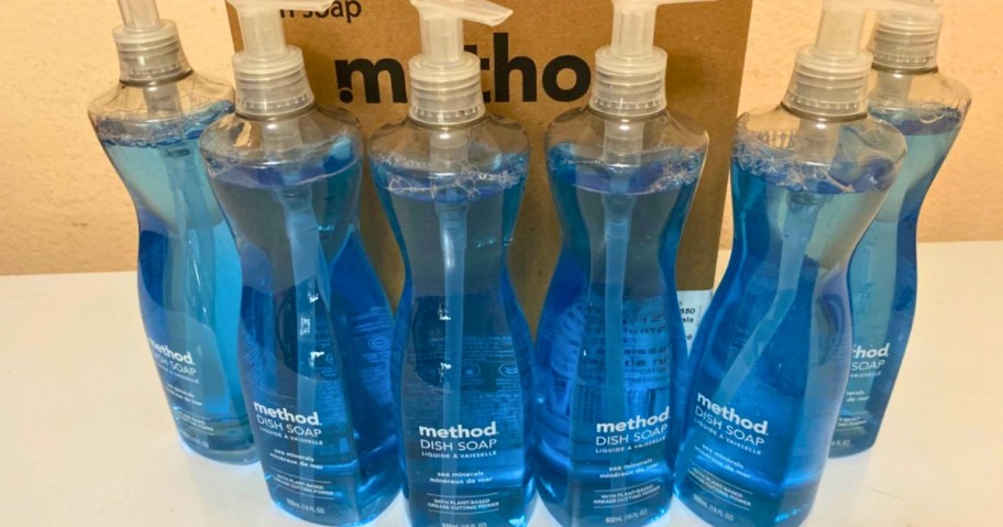 6 bottles of Method Dish soap with blue Sea Mineral soap on a counter, with a box behind them