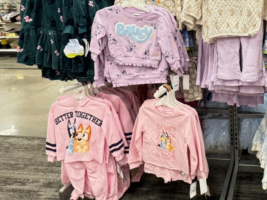 purple and pink toddler Bluey shirts and outfits on display at Target