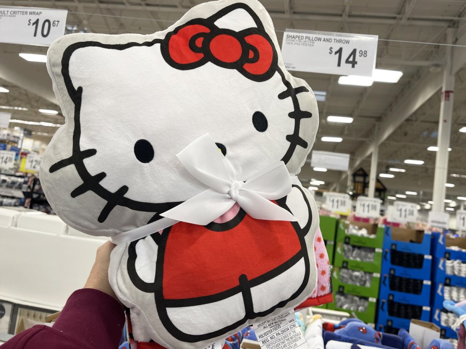 hand holding up a Hello Kitty Pillow and Throw Set