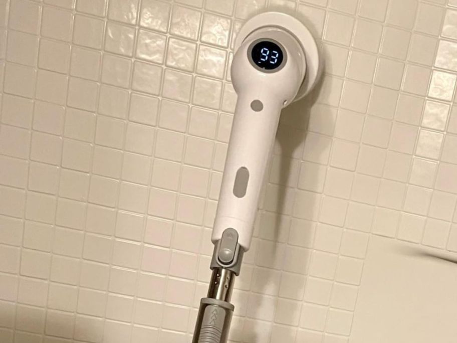 A maxdoria POwer Scrubber cleaning tile in a shower