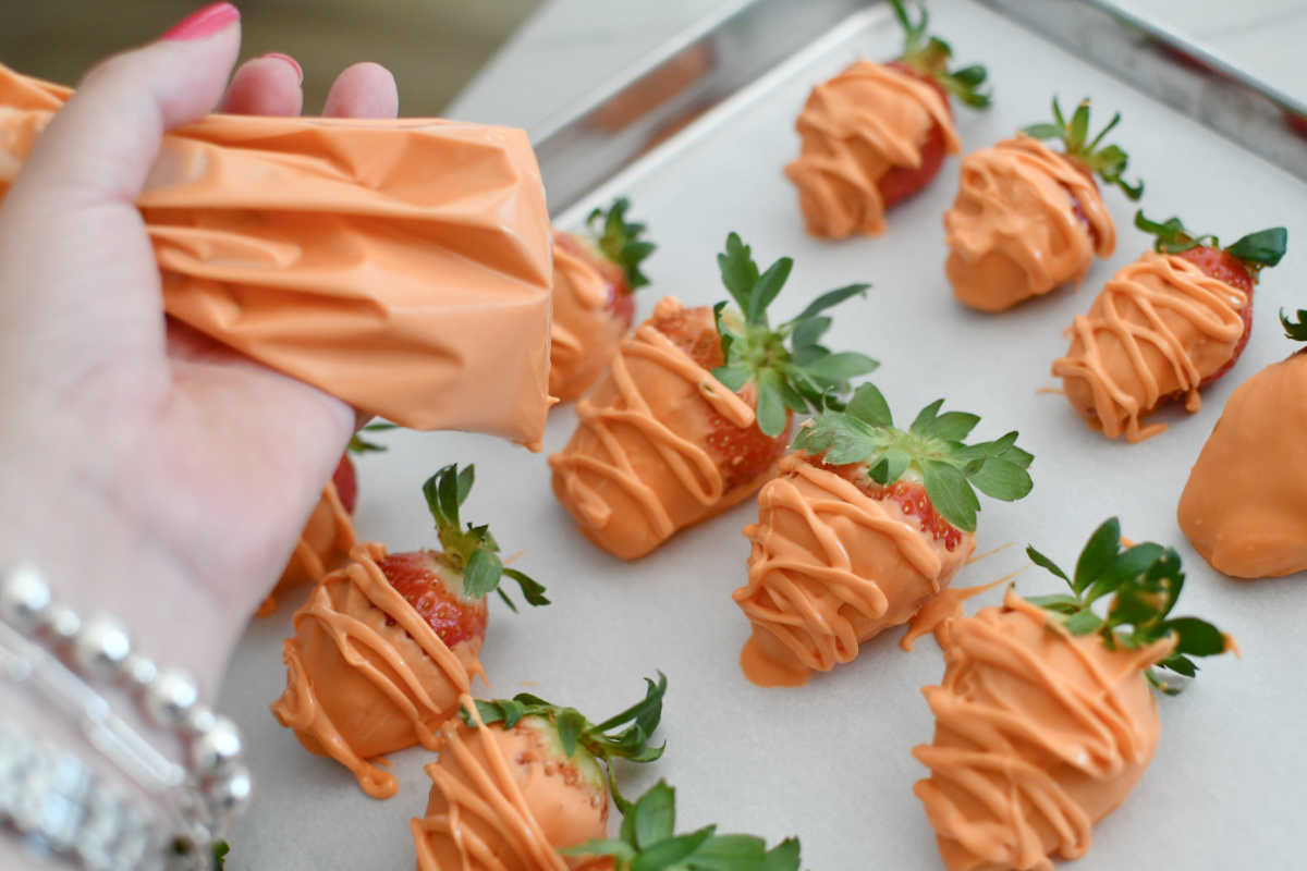 adding lines across orange strawberries with orange candy melts