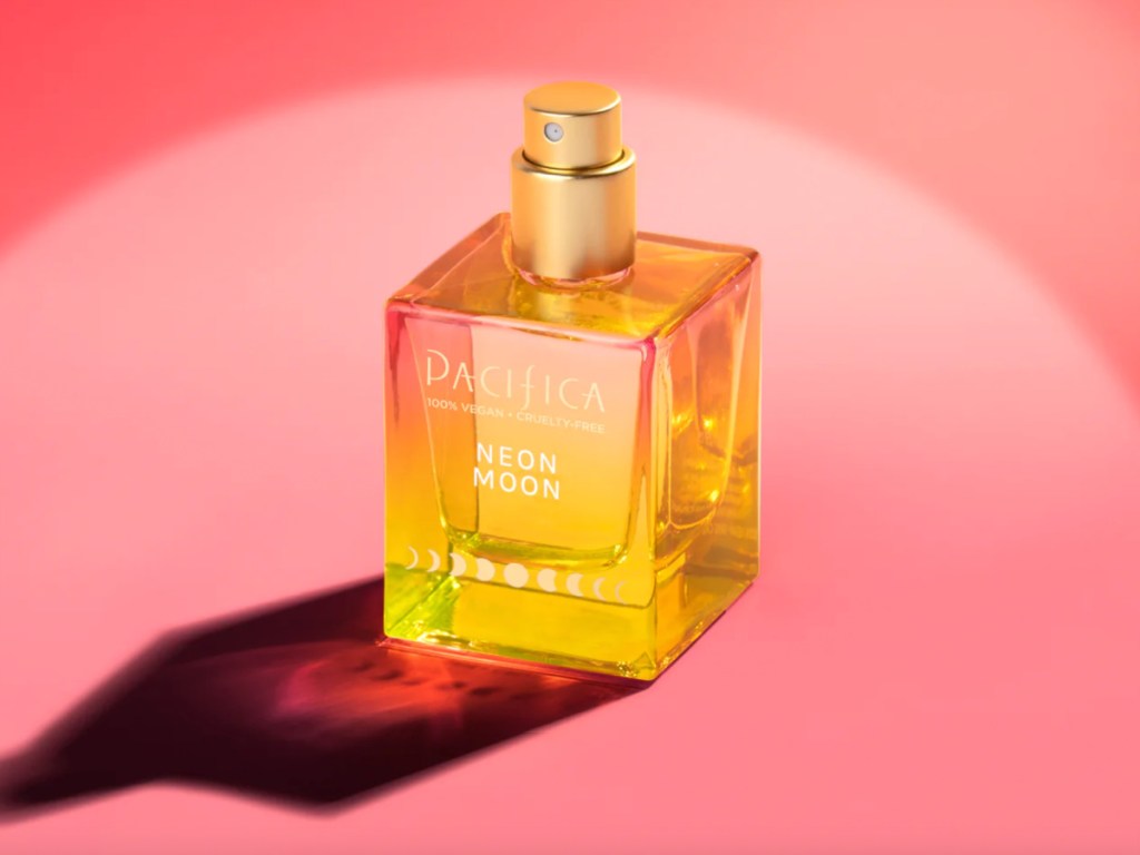 bottle of perfume with pink background