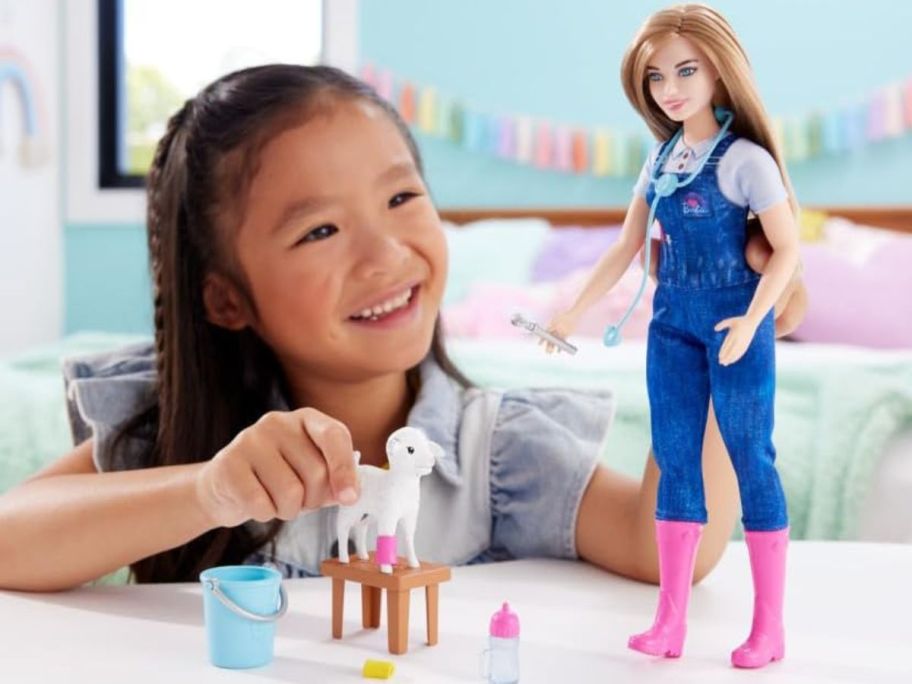 child playing with barbie farm vet doctor