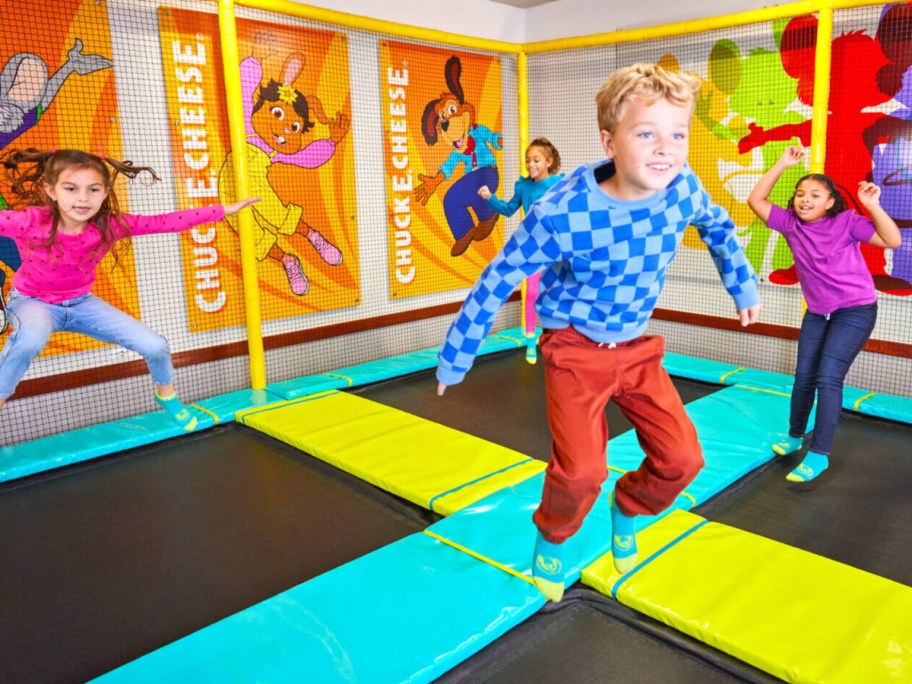 kids jumping on trampolines at Chuck E Cheese