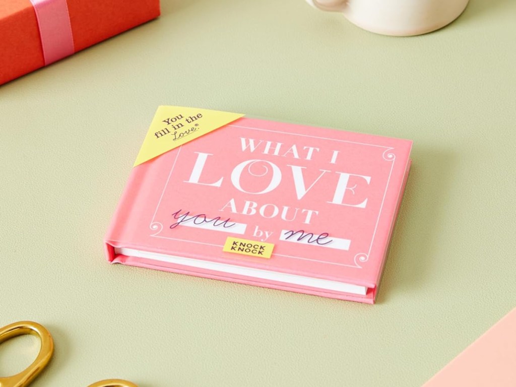 pink book on green table