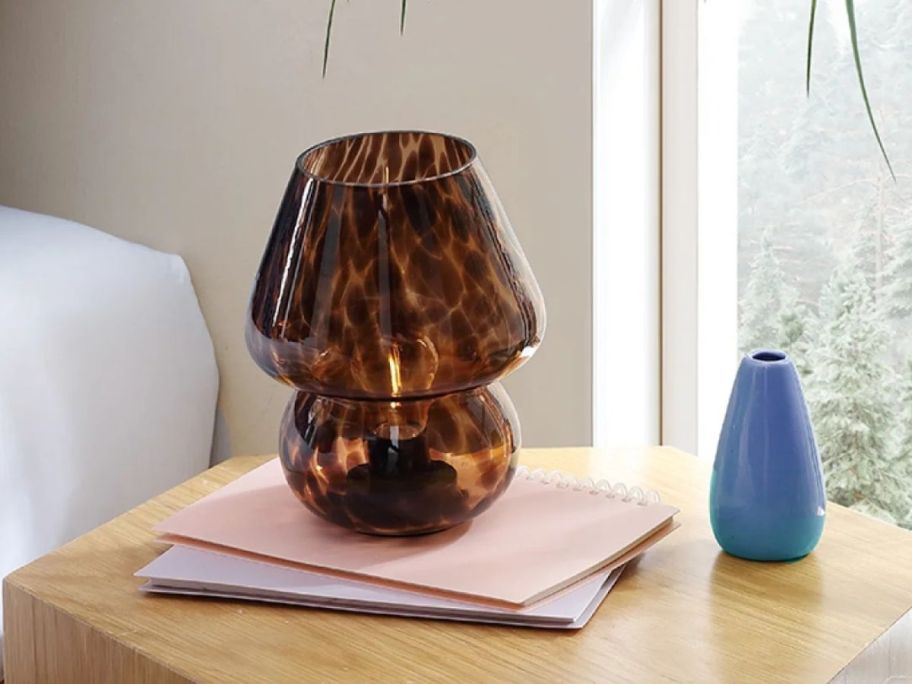 brown Urban Shop 8" Tortoise Glass Table Lamp on desk
