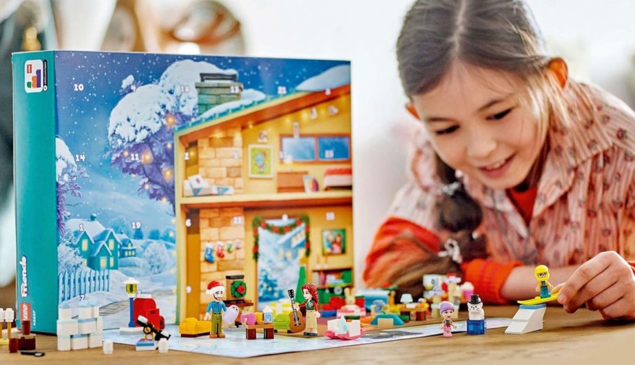 girl playing with lego advent calendar pieces 