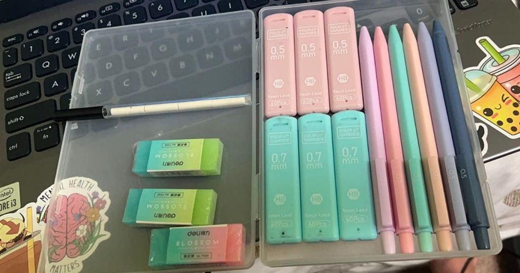 pastel colored mechanical pencil set in a storage case sitting on an open laptop