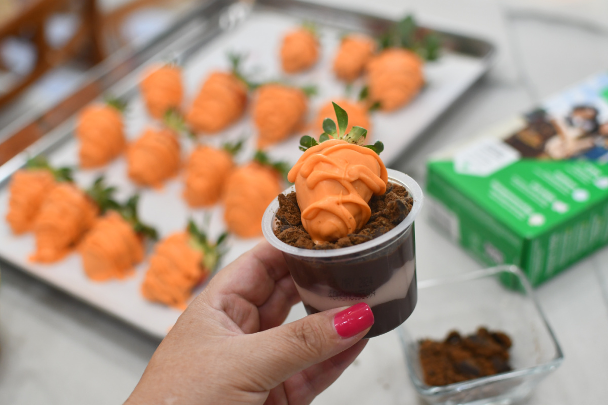 orange carrot strawberry in a pudding cup with cookie crumbs