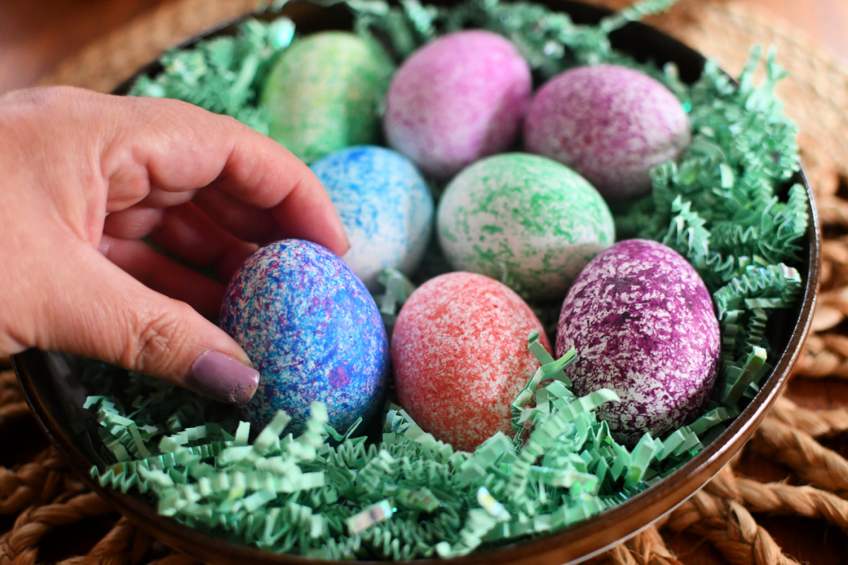 placing speckled eggs on a plate