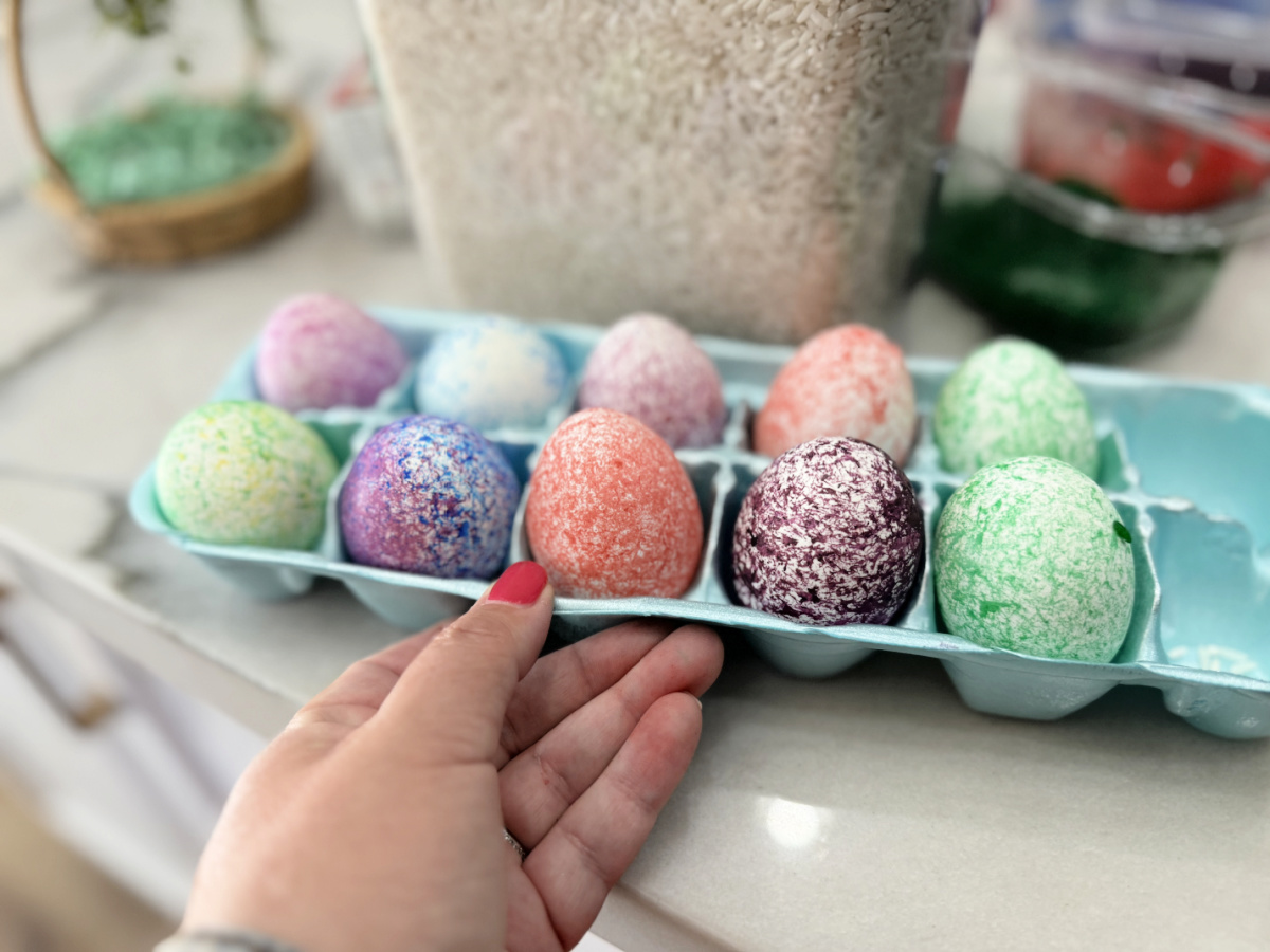 speckled easter eggs in an egg carton container after dying them