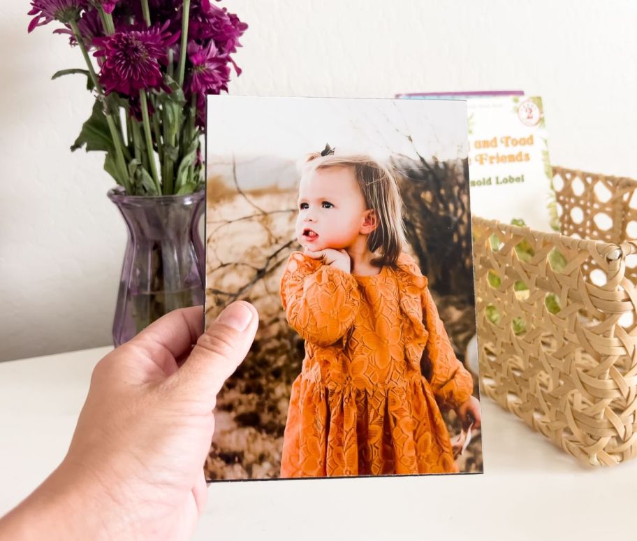 a womans hand displaying a Walgreens 5x7 wood panel print