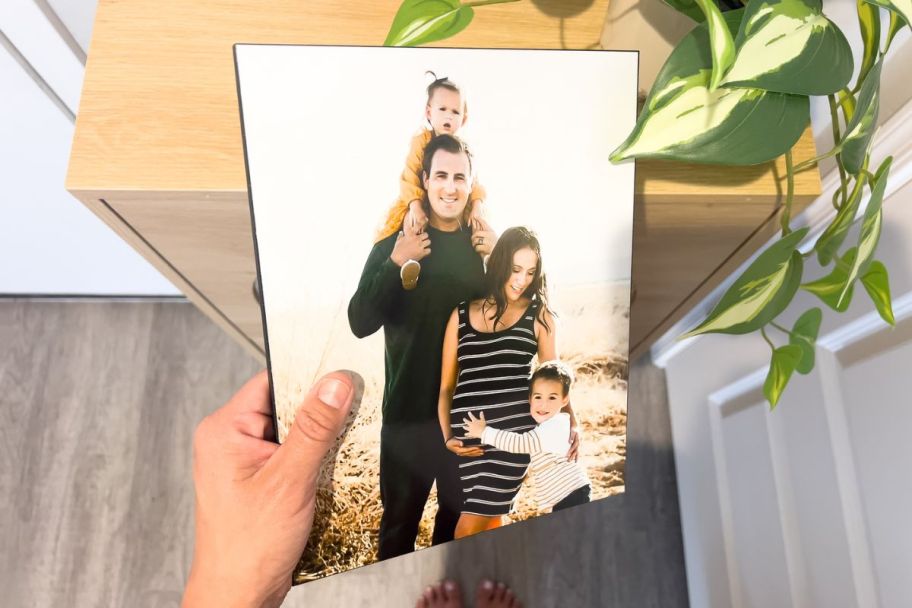 a womans hand displaying a Walgreens 8x10 wood panel print