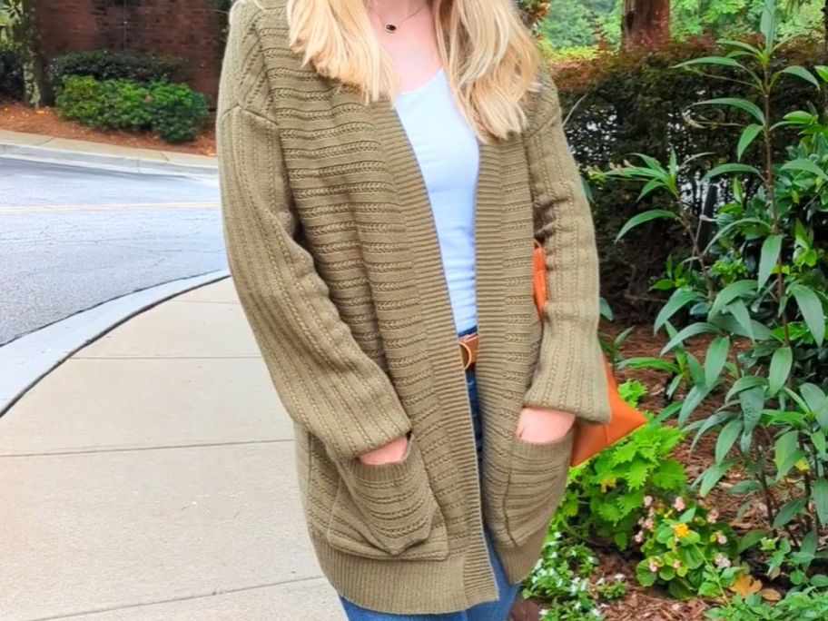 woman wearing green cardigan on street 