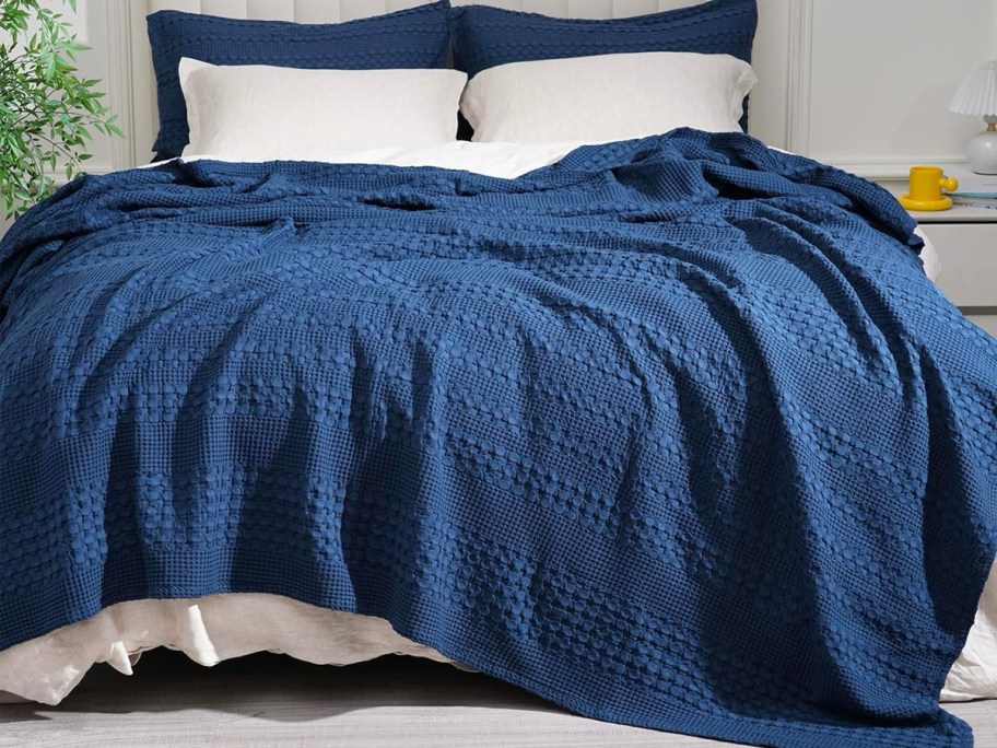 100% Cotton Waffle Weave Throw Blanket on a bed