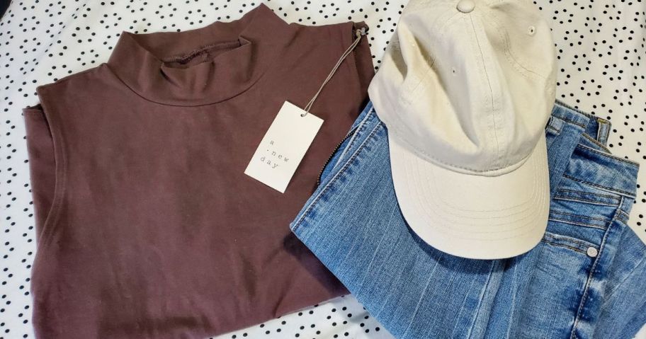A Neew Day Bodysuit with jeans and a hat