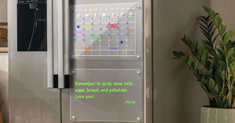 A Fridge with 2 Acrylic Calendars on one of the doors