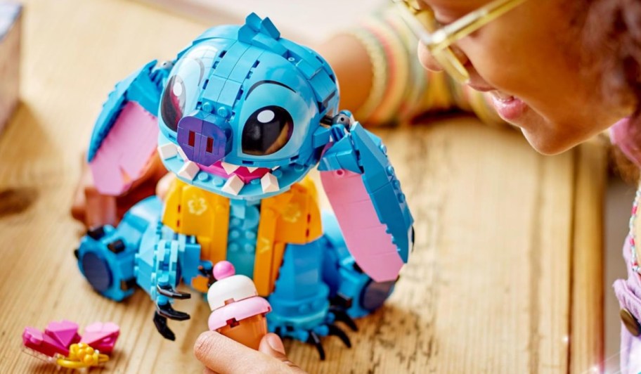 girl playing with Disney Lego Stitch