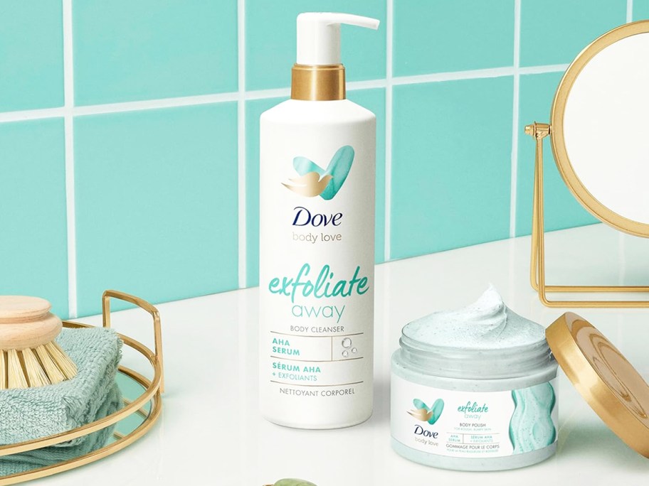 bottle of Dove Body Love Exfoliate Away Cleanser near jar of exfoliating scrub