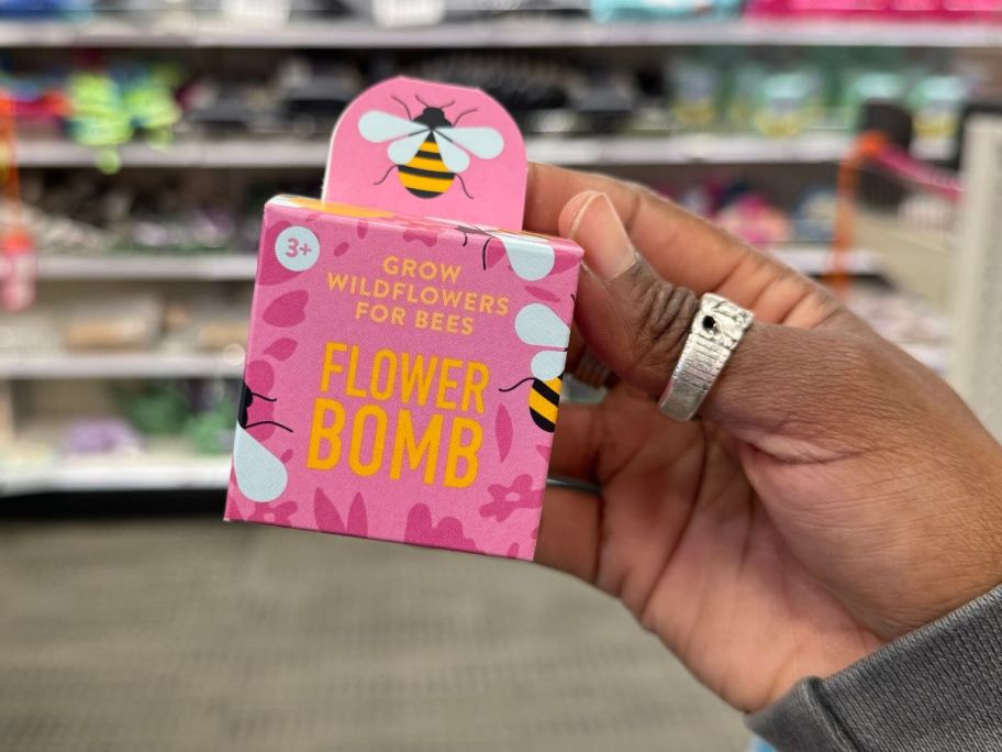 A hand holding a Flower Bomb Grow Wildflowers for Bees