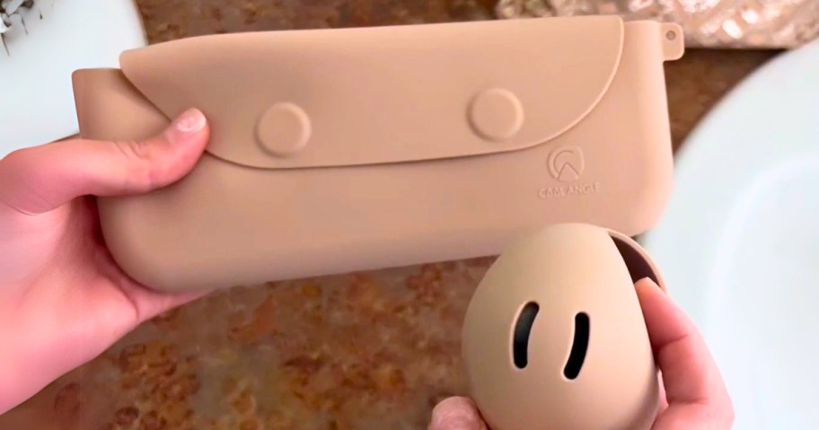 hand holding a makeup brush bag and sponge holder