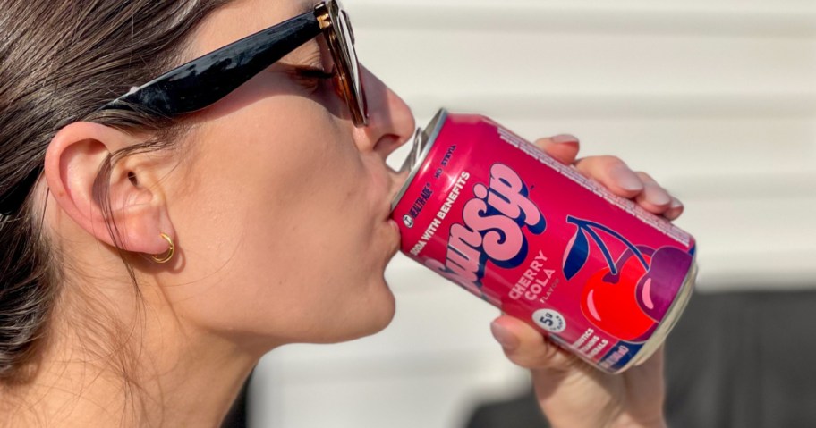 woman drinking Cherry cola flavored Prebiotic soda