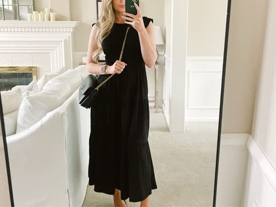 A woman wearing a MEROKEETY Women's Flutter Short Sleeve Smocked Midi Dress 