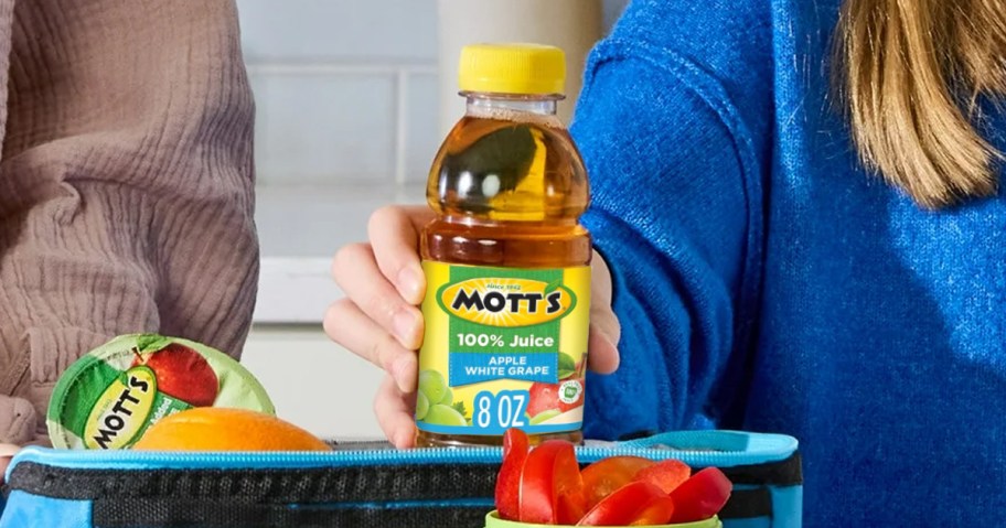 Mott's Apple White Grape Juice Bottle being held by a girl 