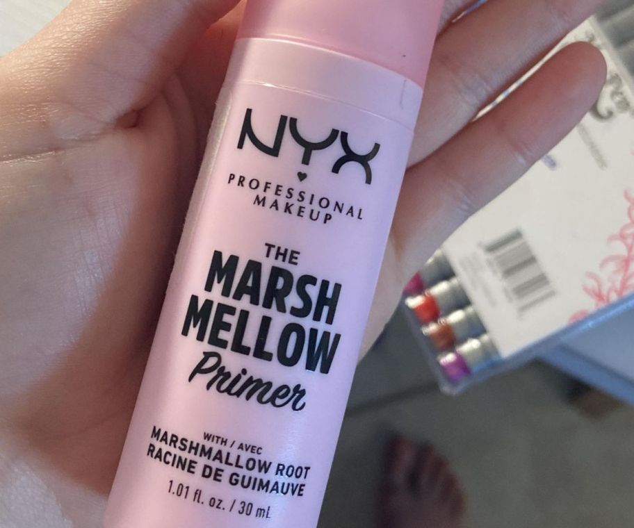 A hand holding a NYX Marshmellow Primer