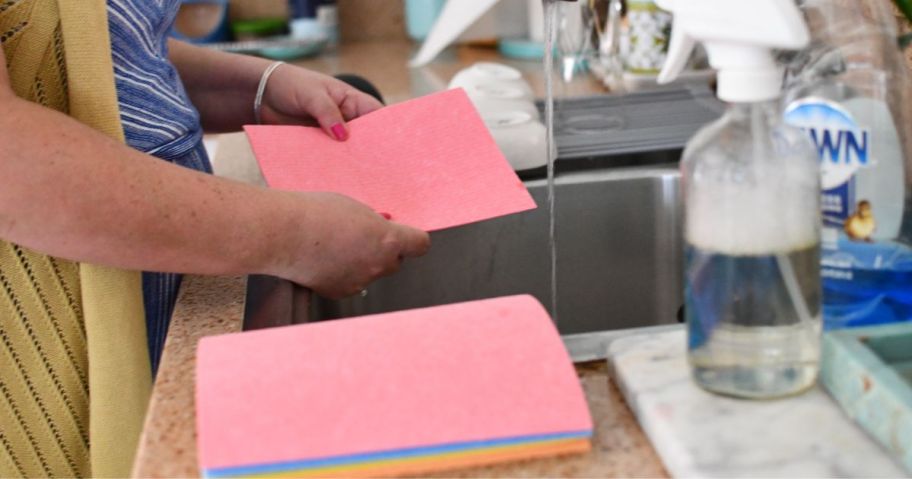 A woman washing Swedish dishcloths