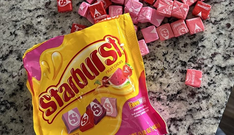 open bag of Starburst FaveREDS Fruit Chews with individual chews laying around it