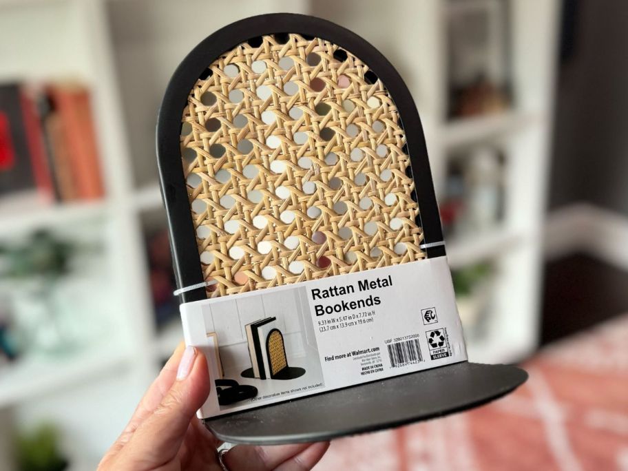 hand holding a set of metal and rattan bookends from Walmart