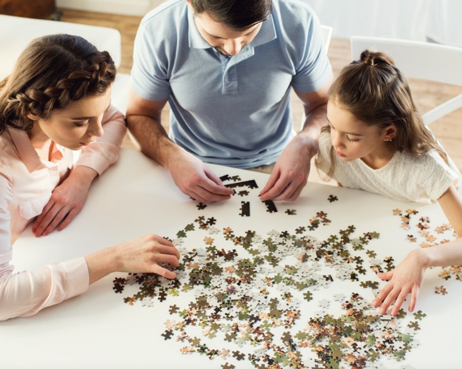 dad and two girls doing photo puzzle