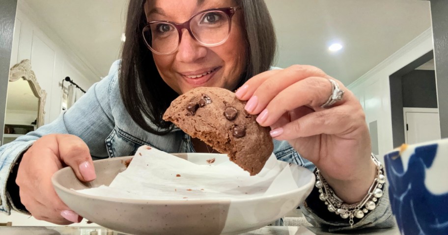 holding a chocolate protein cookie