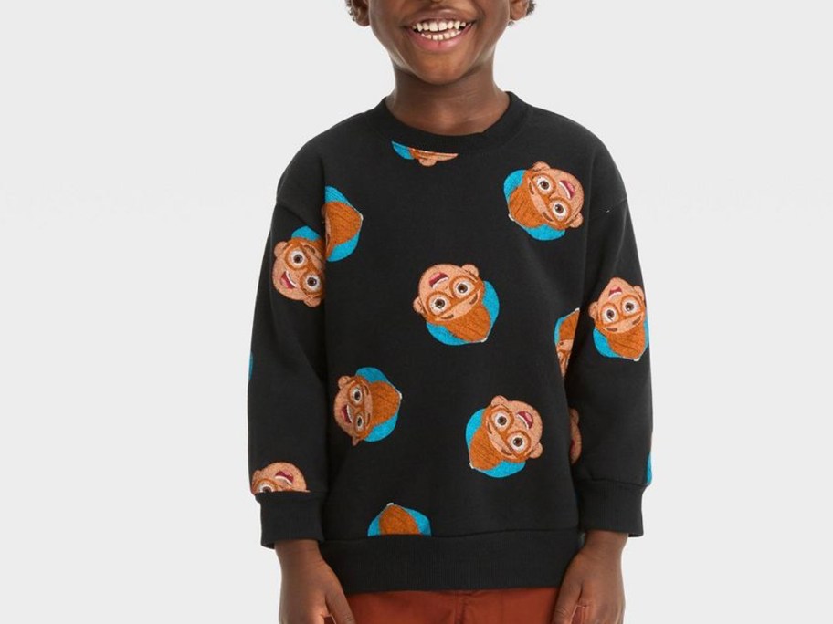 boy wearing black blippi sweater